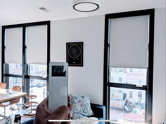 Floor to ceiling blinds and remote control that powers them. Blinds are in all rooms.