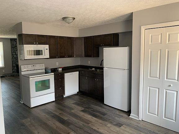 Kitchen with new Fridge and above the range Microwave. Fridge has ice maker, newer Dishwasher, newer . range. Cabinets and countertops all newer (replaced 3 years ago)