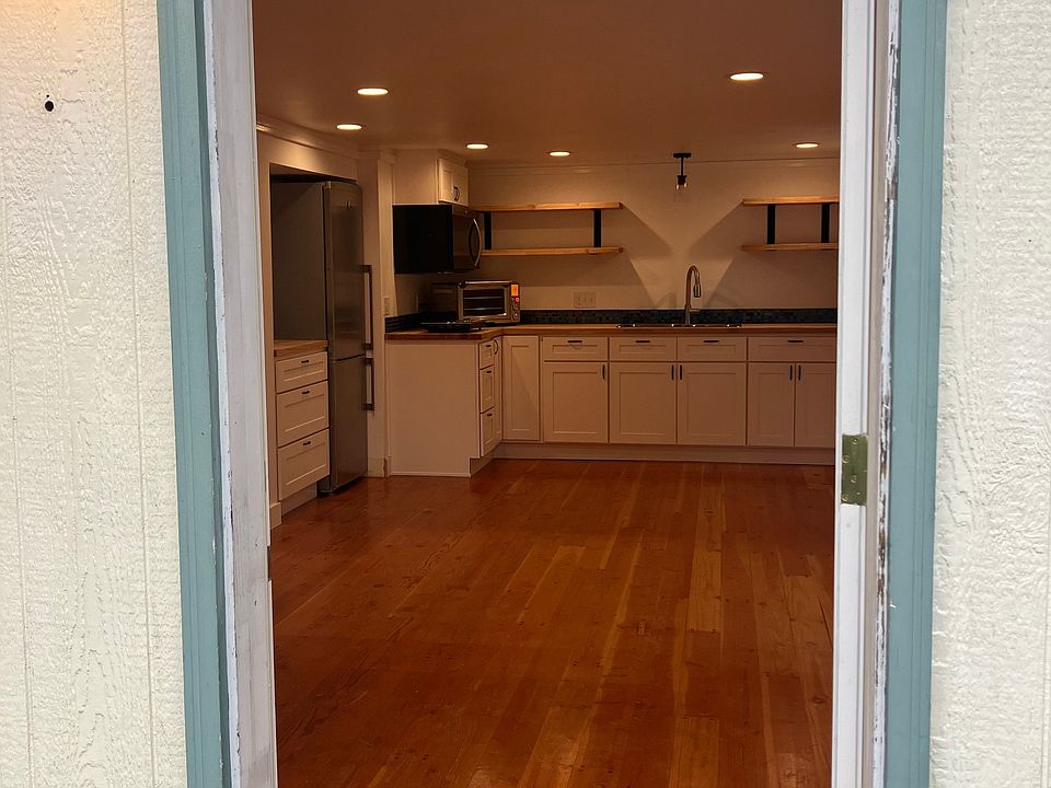 View from front door. Living room in front of the kitchen.