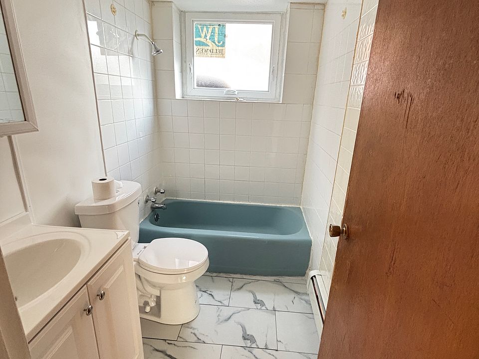Updated bathroom with new toilet, new floor, new window, new sink with cabinet storage underneath, and medicine cabinet with mirror and storage