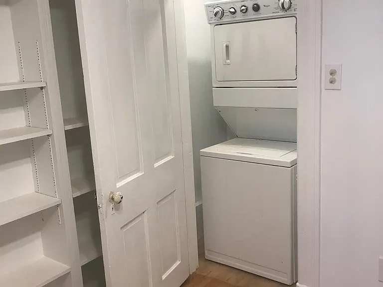 Stack unit washer/drier in a closet.