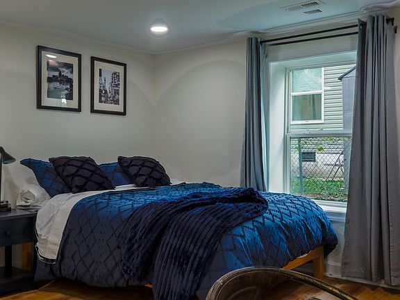 Queen bedroom with TV and desk and big closet