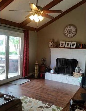 Family Room. Family room with vaulted ceiling and exposed beams, masonry fireplace, and a wonderful view of the private back yard.