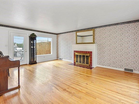 Large living room with a fireplace and access to the back deck.