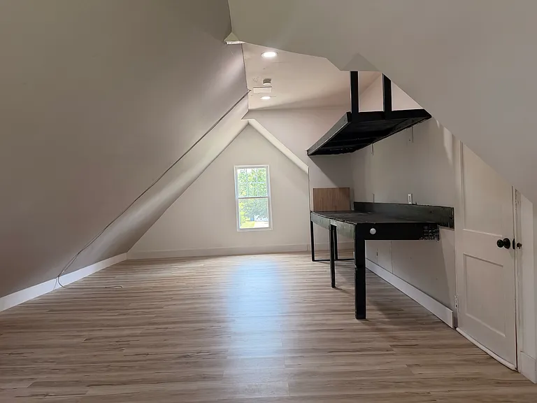 Large bonus room / flex space above the garage with sloped ceilings, new flooring and natural light