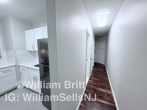 Hallway Leading to Exit and Smaller Bedroom and Bathroom