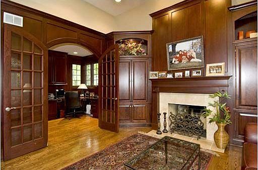 Living room opens to study, rich millwork/built-ins.