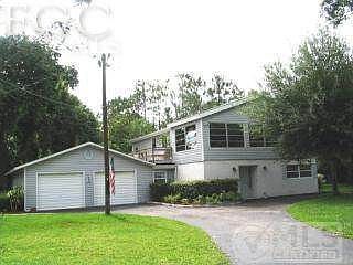Front of home with attached 2 car garage and circular drive