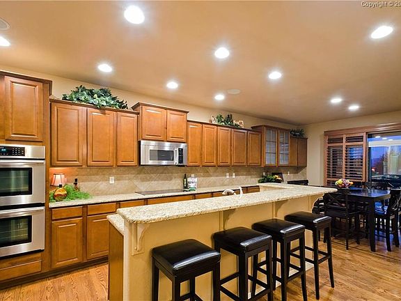 The Gourmet Island Kitchen opens to the Eat-In Nook and features a pantry, break