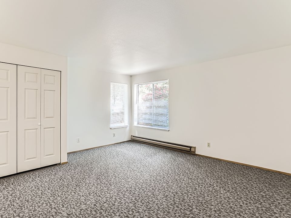 There are two windows with screens in the main living area and a garden window in the kitchen.