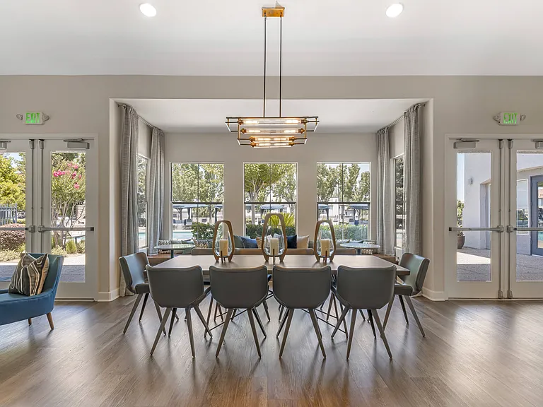 The clubhouse features large tables ideal for gatherings, whether you're hosting a small get-together, working on a project, or enjoying a meal with friends at Ascent at the Galleria.