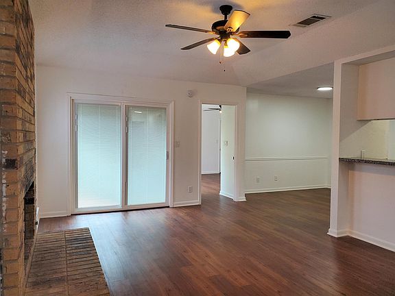 Living room & View of Dining & Primary Bedroom