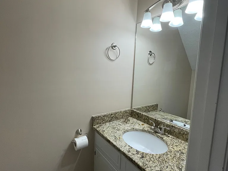 Walking from the front door toward the kitchen, the half bath is the 1st door on the left before entering the kitchen