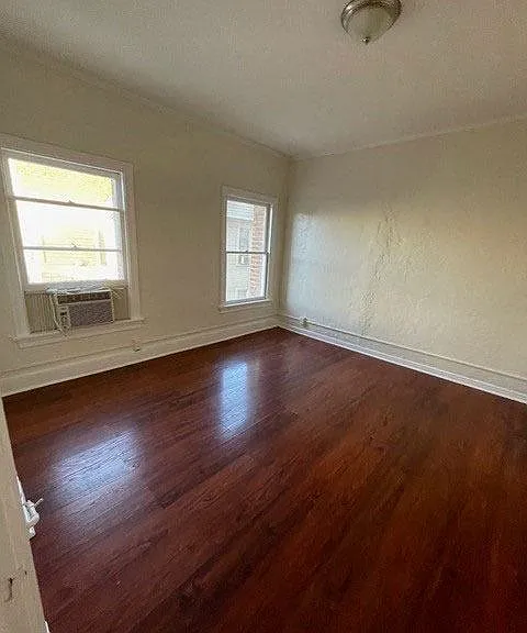 Great natural light and beautiful hardwood flooring in bedroom at Molino Del Mar Apartments in Pasadena, California.