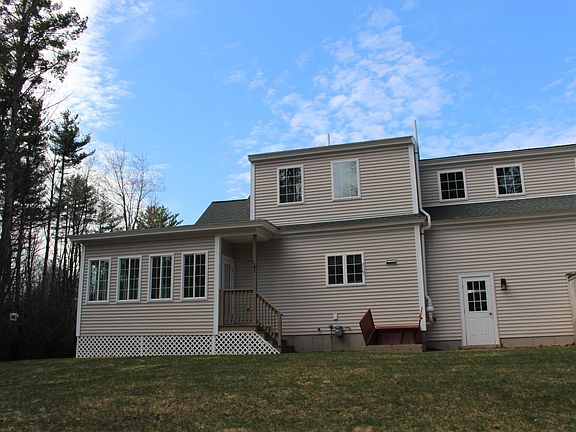 Back of home with patio and 2nd entrance to sun-porch
