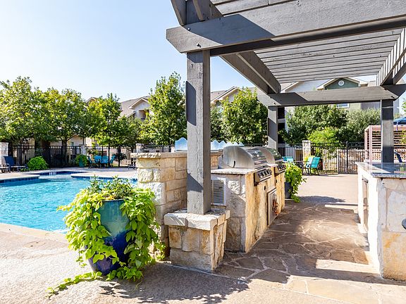 Entertain poolside with an outdoor grilling area and dine al fresco
