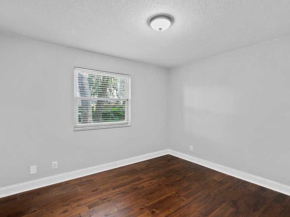 Updated room with floor to ceiling built ins and toy chest.