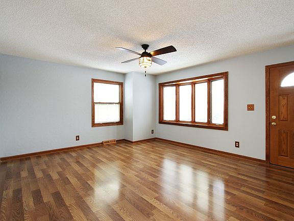 Spacious Living Room with Pella Windows that have built in blinds.