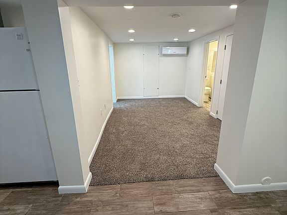 Bright open living area with recessed lighting and new flooring