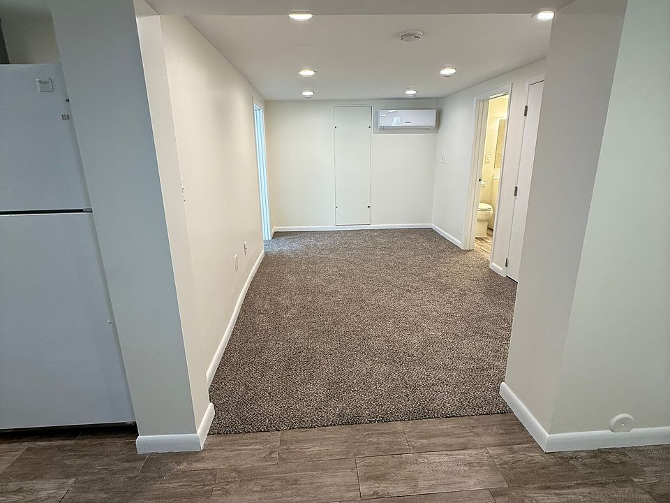 Bright open living area with recessed lighting and new flooring
