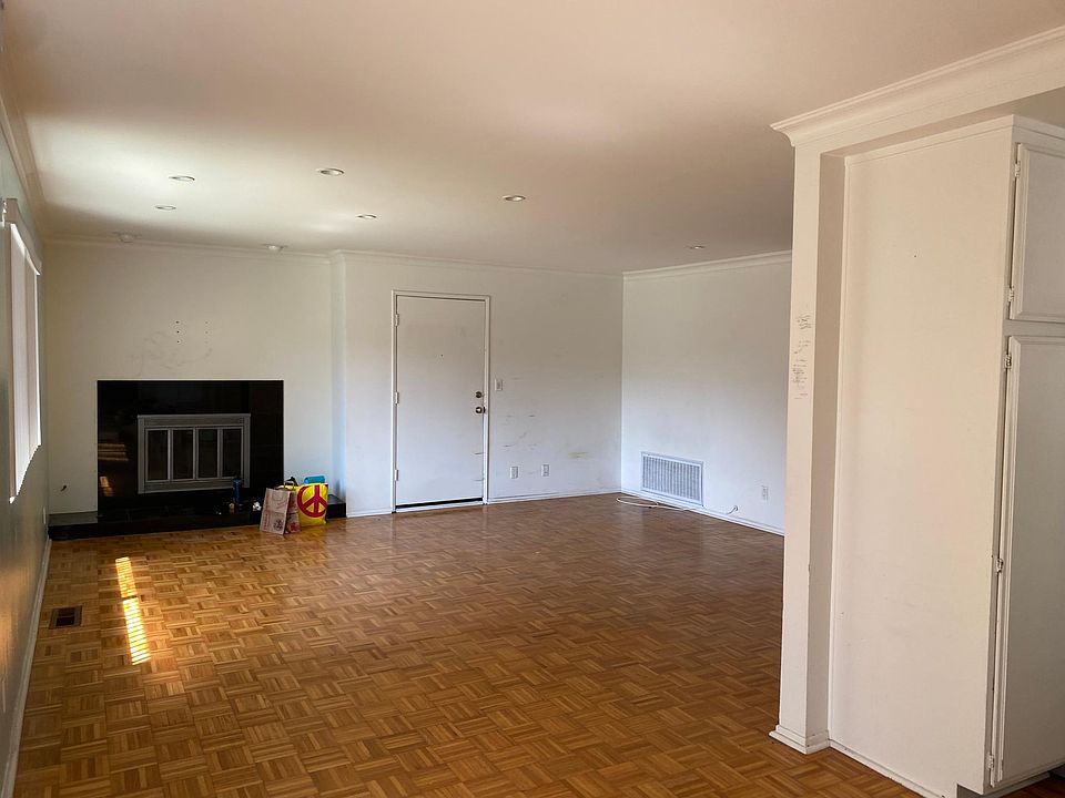 Living room area with gas fireplace. Picture taken from eating area which has sliding door to patio