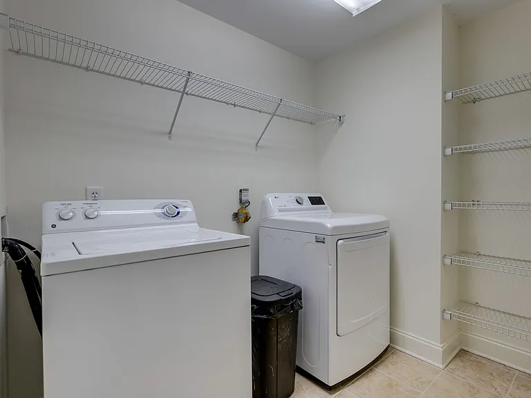 Laundry room with pantry space adjacent to the kitchen. WASHER/DRYER IS INCLUDED WITH RENT.