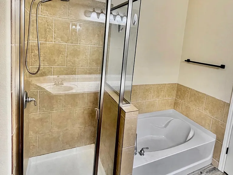 Primary bathroom, walk-in shower, deep soaking tub, tile flooring