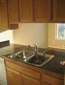 Remodeled kitchen with new maple cabinets and granite countertop.
