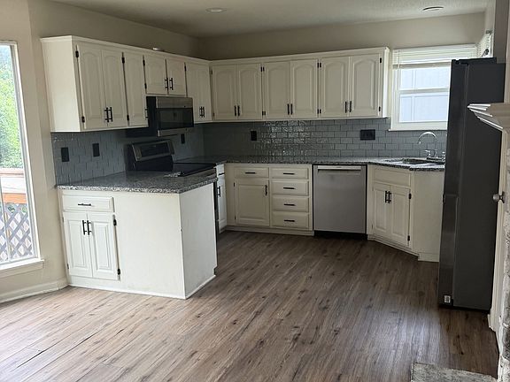 Everything in this stunning kitchen has been redone -- newly painted cabinets, tile backsplash, granite countertops, and appliances. Oh yea, don't forget the new light fixtures, cabinet hardware, and door hardware and blinds. . . and windows! And floori