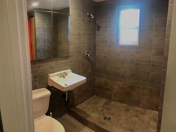 Bathroom with stone tile shower