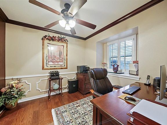 Study/office off the dining room and kitchen. Crown molding, chair rail and hickory wood floor. Shutters cover the double pane windows.