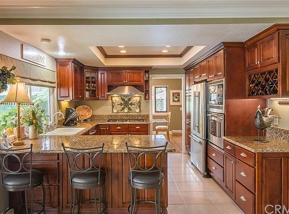 Remodeled kitchen with cherry cabinets and granite counters