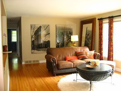 Living room has a large picture window view of backyard