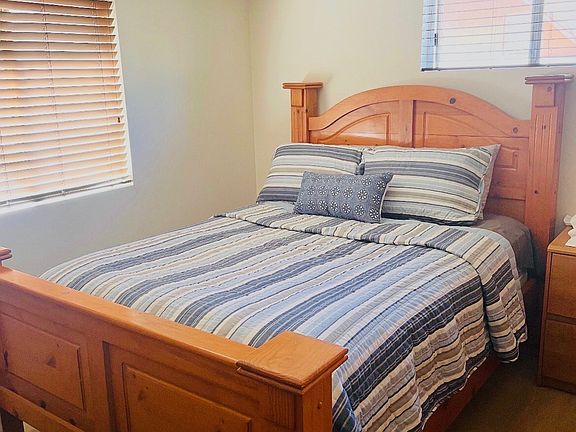 Main bedroom with Queen bed. There is a headboard and nightstand.