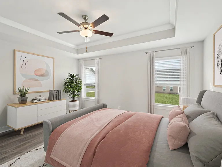 Primary Bedroom with king size bed and large window letting in nice natural light.