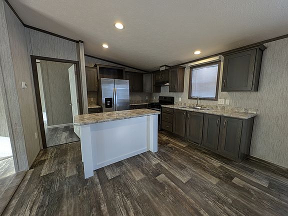 Updated Kitchen with window above sink, side by side fridge with icemaker, and electric stove