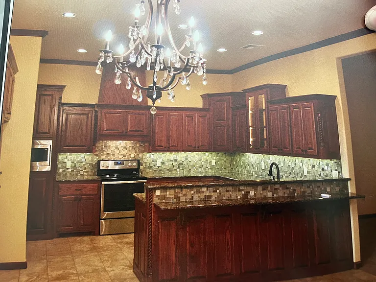 Large open kitchen with stained cabinetry, granite and lots of storage with seating at the bar. You will LOVE this kitchen.