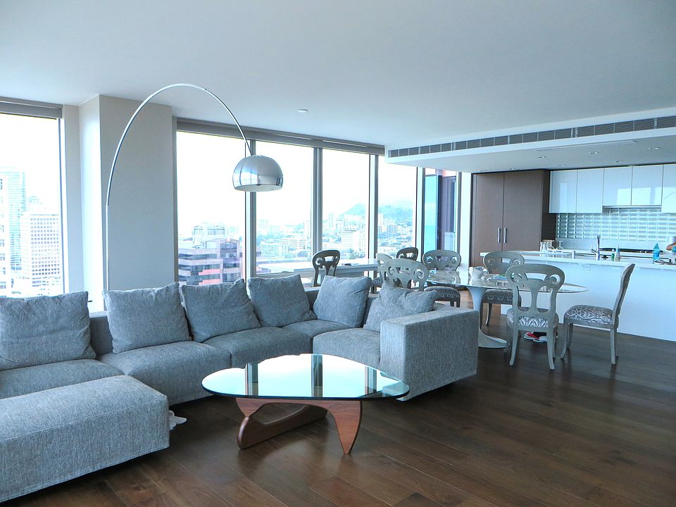 Large living dining area with view of ocean and city