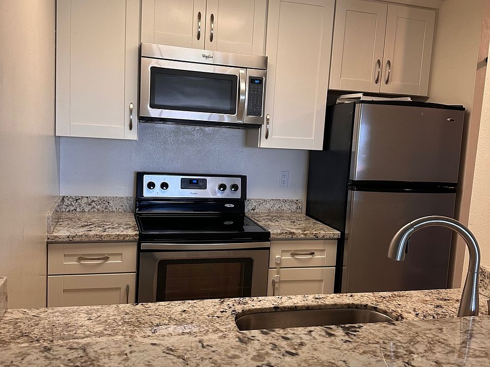 Kitchen with stove, microwave, refrigerator, and dishwasher