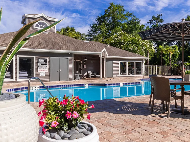 Unwind at one of our poolside tables with umbrellas, offering the ideal mix of comfort and shade on warm Florida afternoons.