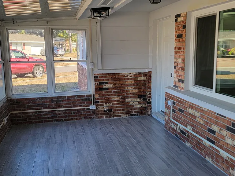 Fully enclosed, tiled front porch.