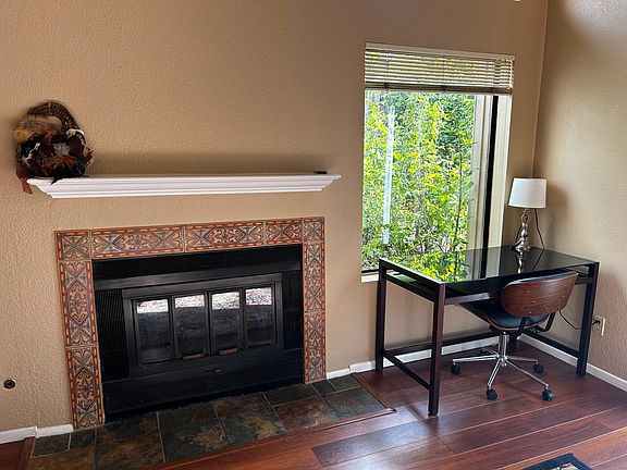 Cozy fireplace in the living room , yes it is furnished and lovely desk for home office ( or move the desk into downstairs bedroom )