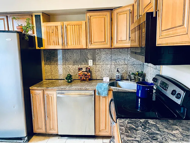 Spacious eat in kitchen with large window and laundry area