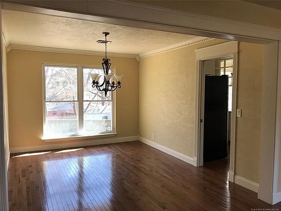 Form dining room with pocket door into the kitchen. New paint, detailed crown molding and large window for ample natural light!