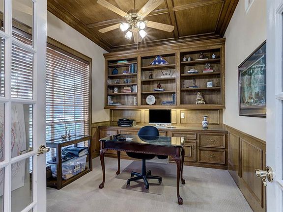 Study has French Doors, built in drawers and shelves and wood paneled ceiling.