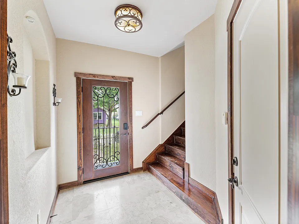 Bright, welcoming entryway featuring beautiful stone floors.