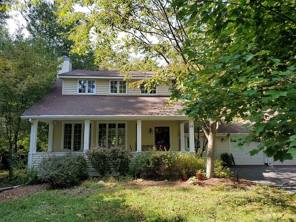 Front of house. Home sits off the road.
