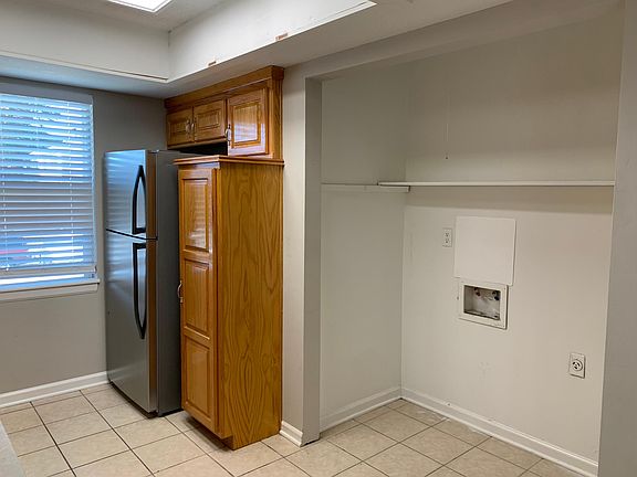 Kitchen with refrigerator, pantry and washer/dryer hookups