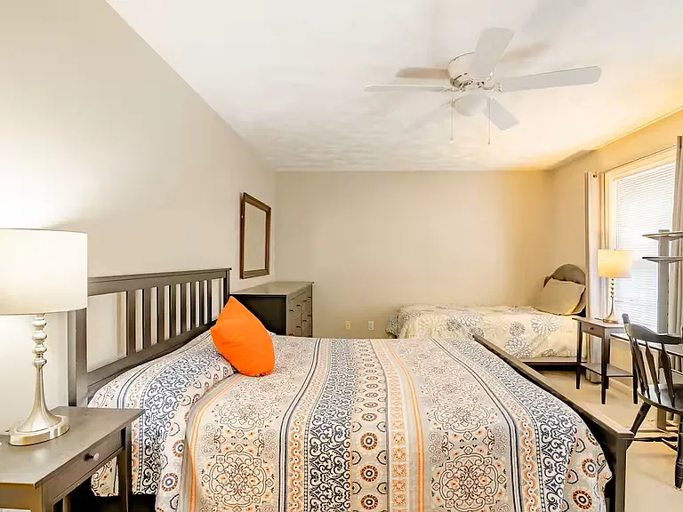Back bedroom features a queen sized bed with memory foam mattress and twin bed. The room also has two walk-in closets, dresser, two nightstands and desk with chair.