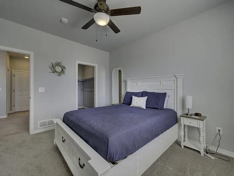 Queen Bedroom
Upstairs bedroom with queen bed, dresser, full-length mirror, and walk-in closet